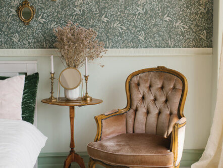 classic-bedroom-interior-brown-armchair-bedside-table